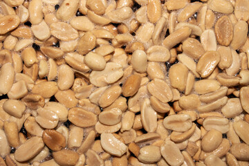 Roasted salted peanuts.Peanuts in butter.Nuts are peanuts background.The texture of roasted peanuts.