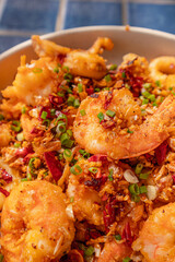 Close up, Deep-fried seafood with chili and salt in plate on blue tiled surface, Thai dish