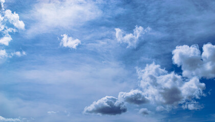 Magnificent cumulus clouds high in blue sky