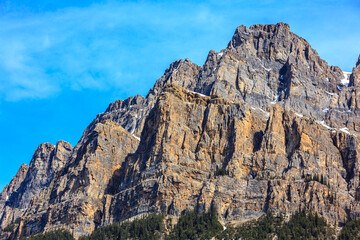 The mountain is covered in snow and rocks