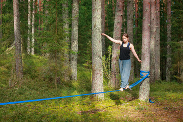 Girl performing balance activity in a lush forest setting