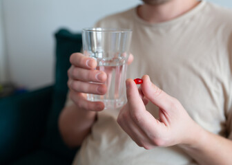 Man with tablet and glass of water, close-up