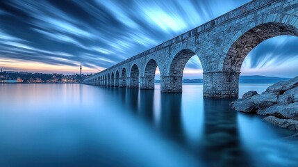 Majestic Stone Bridge Over Serene Lake at Sunset