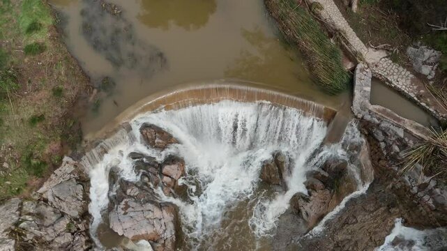 aerial drone view of a small medieval weir in SE Spoain after rainfalls. 4K