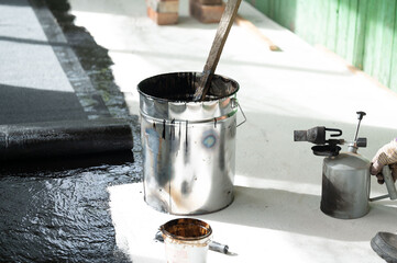 A large bucket of resin for waterproofing the floor in the house.