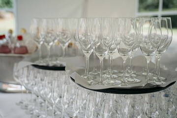 Empty wine glasses on a tray ready for an event.