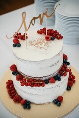 Rustic Wedding Cake with Berries and Love Topper