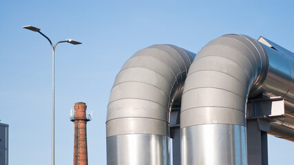 pipeline close-up in the background a brick chimney and a pole with a lantern