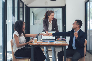 Teamwork Makes the Dream Work: Diverse and enthusiastic business colleagues high-five in a modern office setting, radiating positivity and collaboration.  
