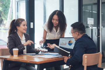 Business Professionals Meeting: Three diverse business professionals engage in a lively discussion, their smiles and gestures conveying collaboration and enthusiasm.