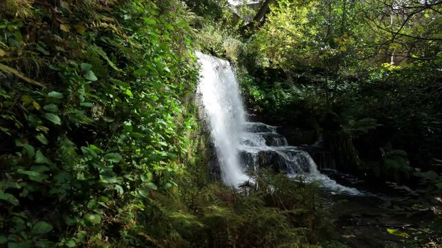 Pull-back drone footage of the Lumsdale Waterfall in Lumsdale Valley in Matlock, Derbyshire, England