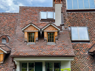Charming spring scene in Thun, Switzerland, with historic buildings, a flowing river, and a picturesque sky.
