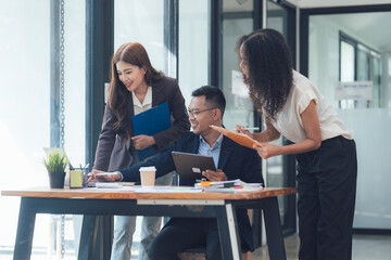 Office Collaboration: A team of professionals collaborating on a project, engaged in a lively discussion, showcasing teamwork, and idea exchange in a modern office setting.  