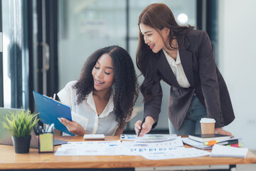 Collaborative Businesswomen reviewing documents 