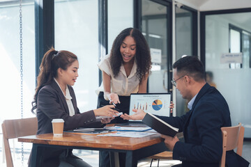 Business Meeting Success: A diverse team of professionals collaborates in a modern office setting, discussing data and charts, radiating optimism and a shared vision for success.  