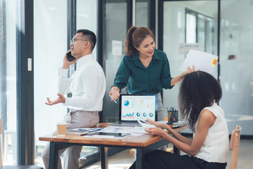 Business Collaboration: A diverse team of professionals engaged in a lively, dynamic discussion around a conference table.