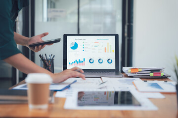 Businesswoman Analyzing Data: A close-up shot of a focused businesswoman analyzing data on a laptop screen in a modern office setting. The image captures the intensity of the task at hand.