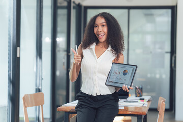 Successful Businesswoman Showing Thumbs Up with Tablet