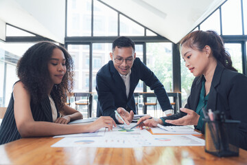 Strategic Business Meeting: Diverse team collaboration, financial analysis, modern office.