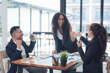 Business Team High Five: A diverse group of business colleagues shares a celebratory high five, radiating energy, enthusiasm, and a sense of unity.