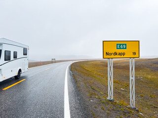Camper van traveling on the e69 road to nordkapp, norway, on a rainy and foggy day