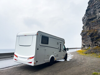 Camper van traveling on the e69 road to nordkapp, norway, on a rainy and foggy day