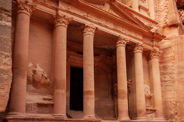 Jordan, Petra, Square in front of temple. Famous Treasury in rock city of Petra. Temple with high columns is carved into sandy sheer cliffs. Petra, Jordan - December 05, 2009