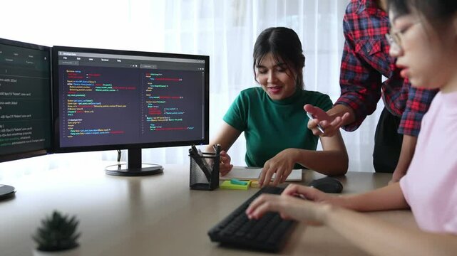 Back end software developer engineer for computer programming working together on debugging writing computing code, solving complex algorithms display on monitor in office. Burgeoning