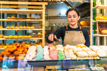 Woman selling artisan pastries in a bakery