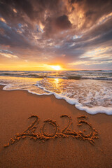 Happy New Year 2025 concept, number lettering on the ocean beach sand and scenic sunrise vertical...