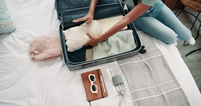 Above, woman and hands for packing, suitcase and clothes for vacation, travel or holiday trip. Female person, preparing and home in bedroom with luggage, tourism and destination as university student