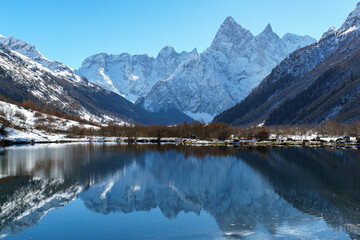 Fototapeta premium The snow tops of Mount Chotcha reflected in Tumanly-Gel or Tumanly-Kol (Foggy Lake) lake. Dombay, Karachay-Cherkessia, Russia