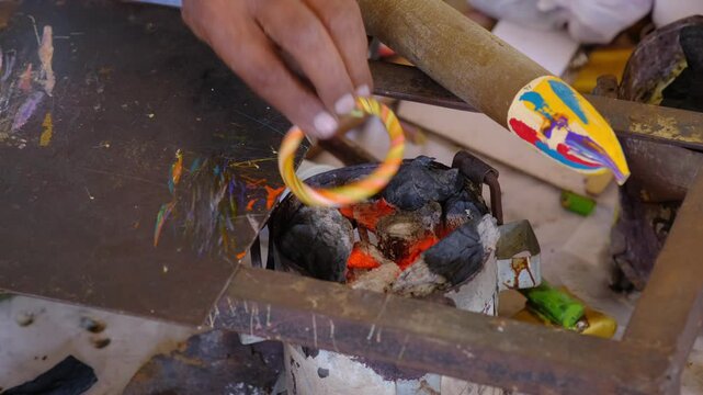 The Making of A Colorful Handmade Lac Bangles, The lac used for making bangles is natural lac which is colored using colored lac by heating it.