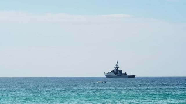 A military ship in the ocean. Concept of maritime defense and national security. Perfect for themes about naval forces and protecting national borders.