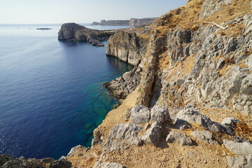 coastline and steep rocky cliffs around the acropolis of Lindos