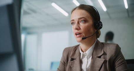 Caucasian woman works in modern office: Female technical support operator or customer manager talks...