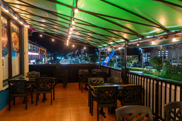 Dining under twinkling lights on a cozy outdoor terrace at night