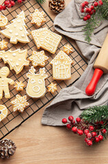 Christmas cookies cooling on rack with festive decorations and rolling pin