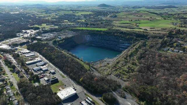 Aerial approaching shot of lake near Frazier Quarry in suburb of Harrisonburg, Virginia. New developed housing units around lake. Wide shot.