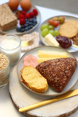 Assortment of various breakfast foods and drinks on the white table. Selective focus.