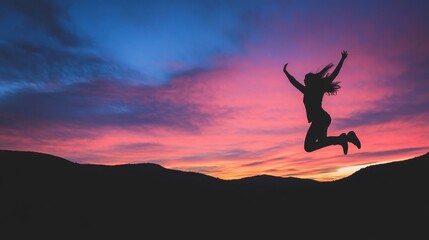 Silhouette of a Person Jumping Against a Vibrant Sunset Sky