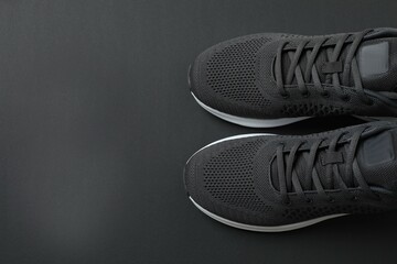 Pair of stylish sneakers on a black background