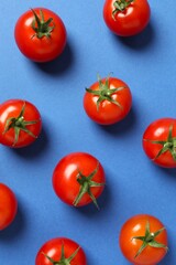 Flat lay composition with fresh cherry tomatoes and basil on color background. Ripe vegetables
