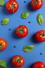Fresh red tomatoes, pepper and basil on color background, top view