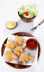 Fried Chicken Drumsticks and Vegetable Salad food on a white background
