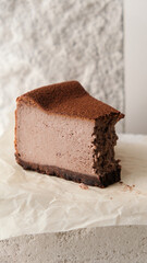 Close-up of a fork breaking a chocolate cake. chocolate cheesecake on a light background