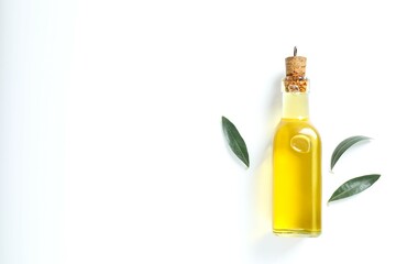 Bottle of fresh olive oil and olives with leaves on white background