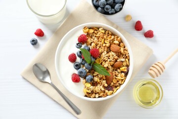 Delicious granola with berries and yogurt on the table