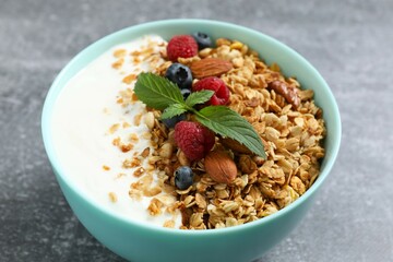 Delicious granola with berries and yogurt on the table