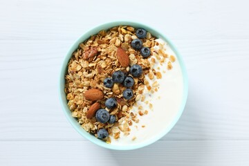 Delicious granola with berries and yogurt on the table
